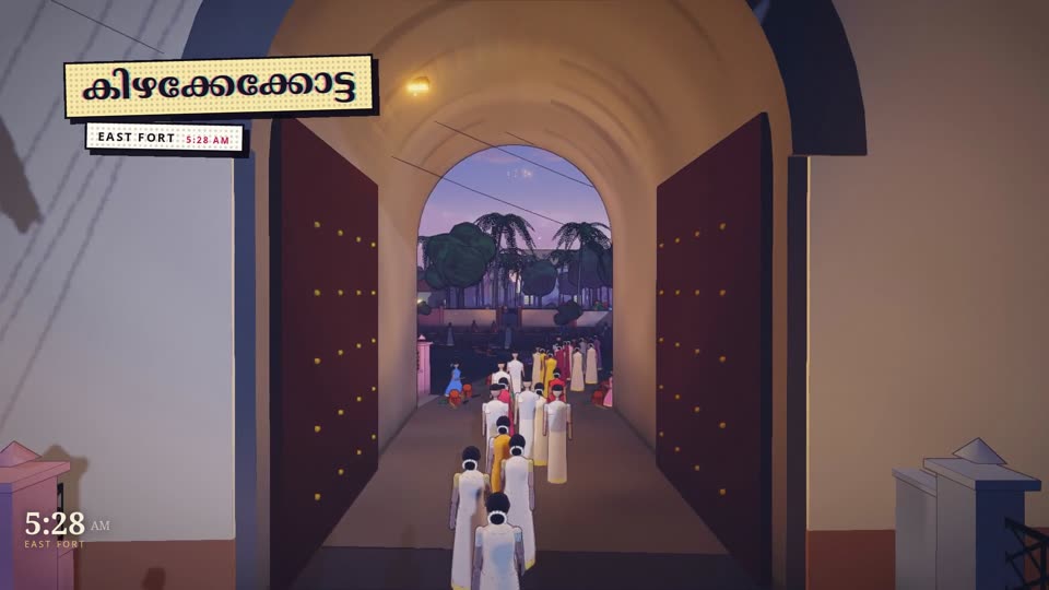 Women in white and gold sarees walking through the stone arch of East Fort at night